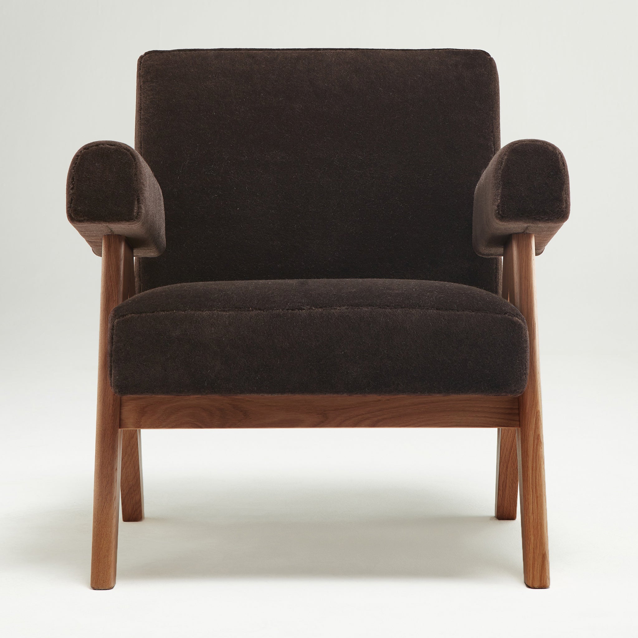 Front view of an authentic chandigarh lounge chair, pierre jeanneret era, walnut oak frame, pierre frey choco teddy mohair upholstery, by Klarel #K35-30