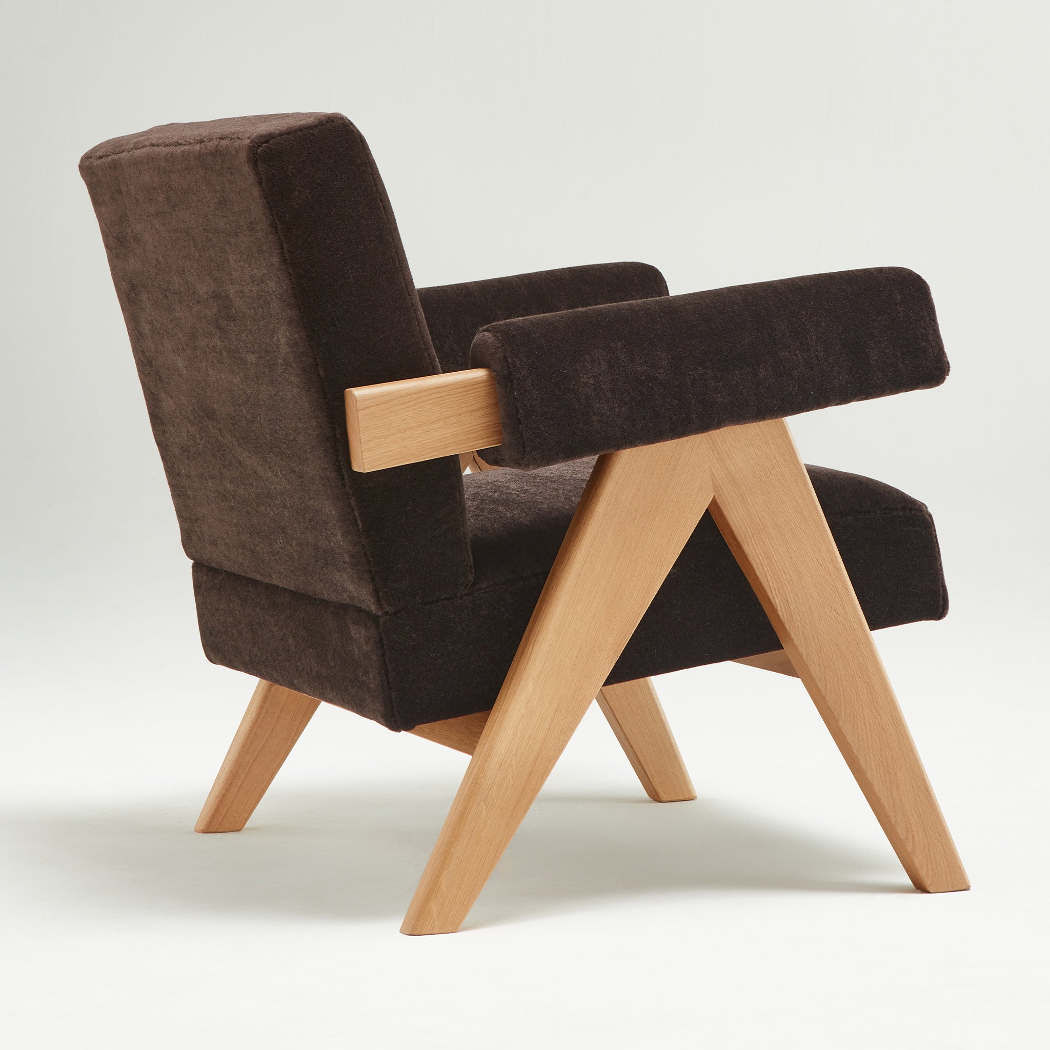 Back view of an authentic chandigarh lounge chair, pierre jeanneret era, natural oak frame, pierre frey choco teddy mohair upholstery, by Klarel #K35-31