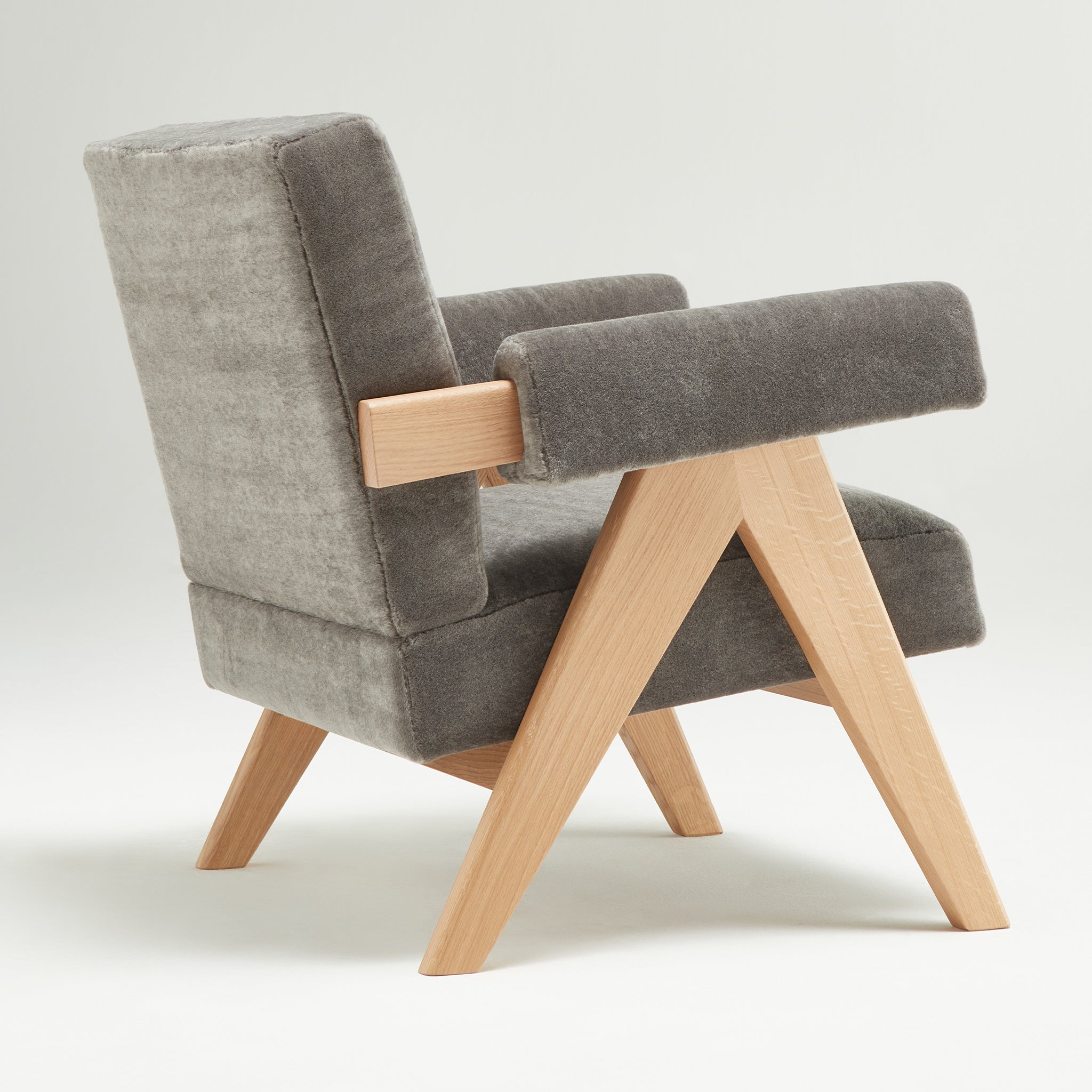 Back view of an authentic chandigarh lounge chair, pierre jeanneret era, natural oak frame, pierre frey elephant teddy mohair upholstery, by Klarel #K35-34