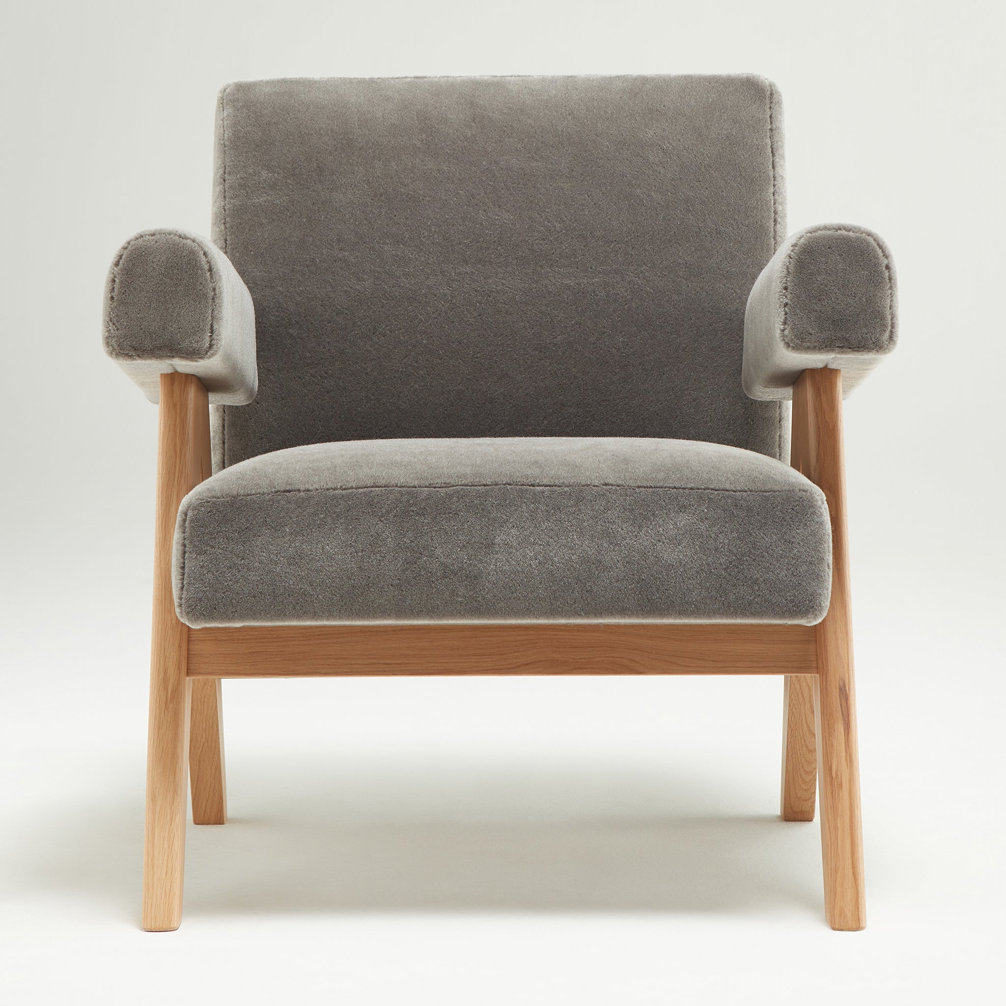Front view of an authentic chandigarh lounge chair, pierre jeanneret era, natural oak frame, pierre frey elephant teddy mohair upholstery, by Klarel #K35-34