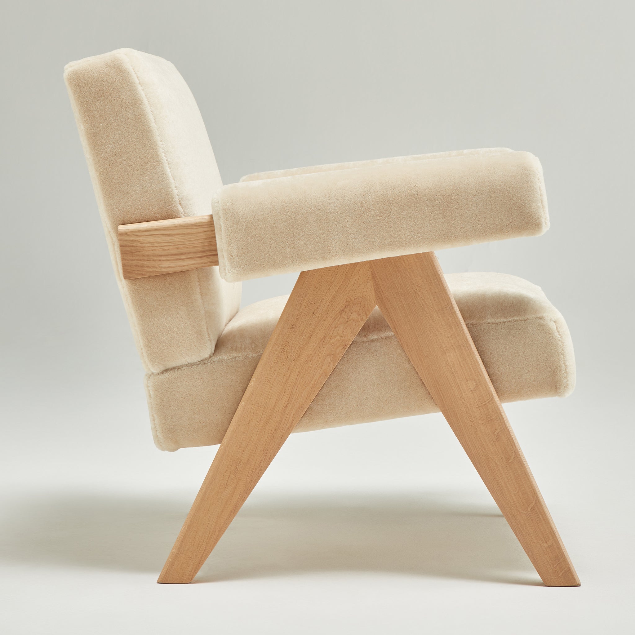 Side view of an authentic chandigarh lounge chair, pierre jeanneret era, natural oak frame, pierre frey sable teddy mohair upholstery, by Klarel #K35-35