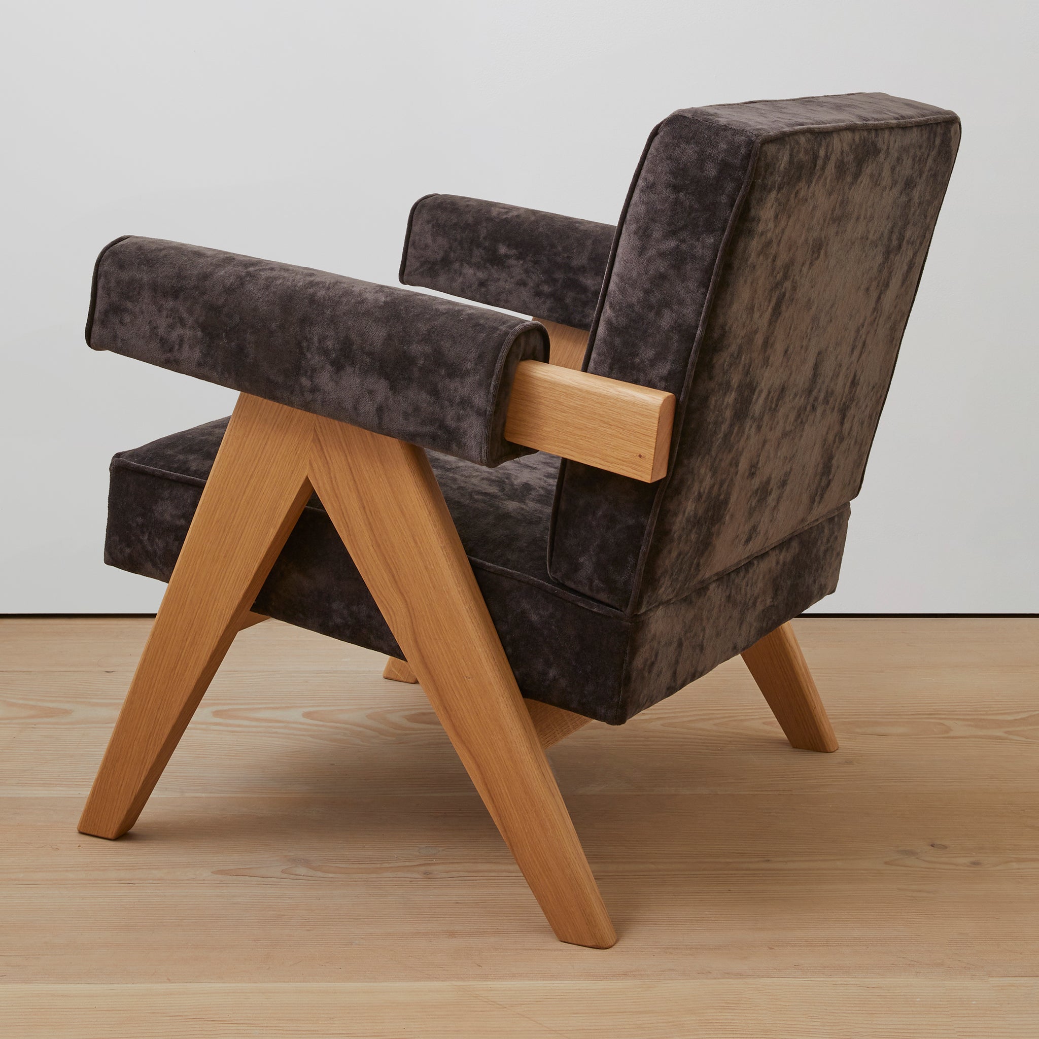 Back view of an authentic chandigarh lounge chair, pierre jeanneret era, natural oak frame, chocolate brown mohair upholstery, by Klarel #K35-36