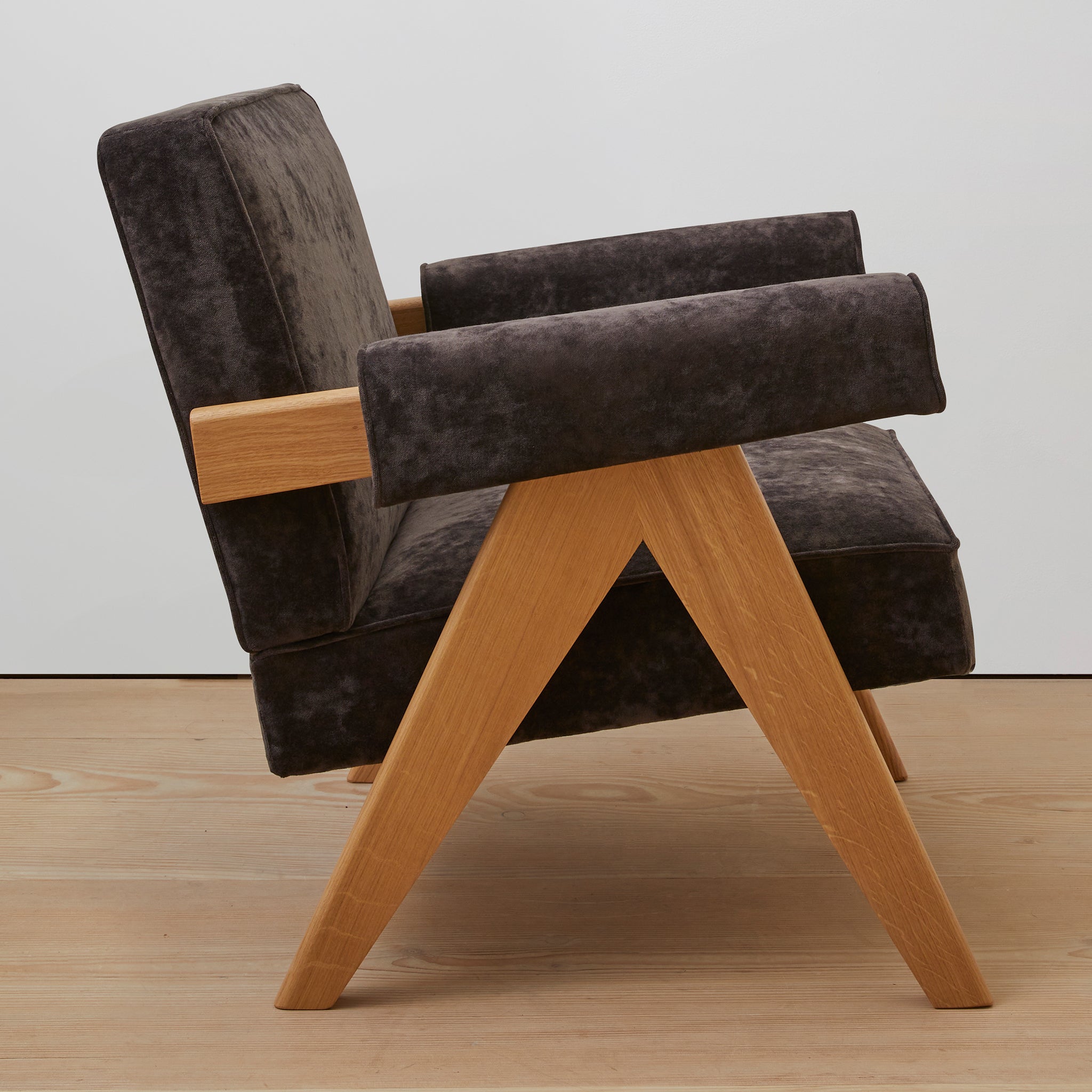 Side view of an authentic chandigarh lounge chair, pierre jeanneret era, natural oak frame, chocolate brown mohair upholstery, by Klarel #K35-36