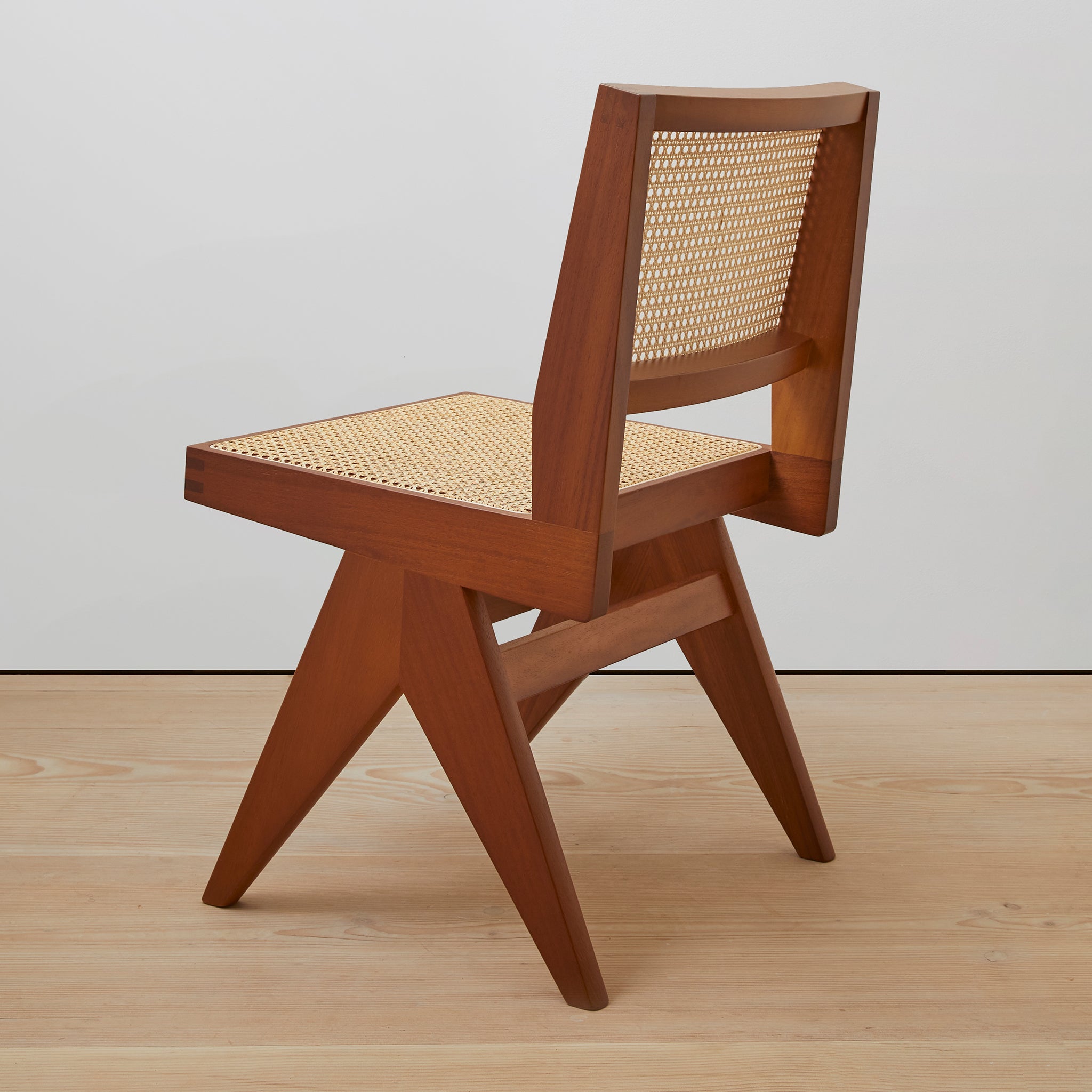 Back view of an authentic chandigarh side chair, pierre jeanneret era, teak frame, viennese cane, produced by Klarel. #K38-1