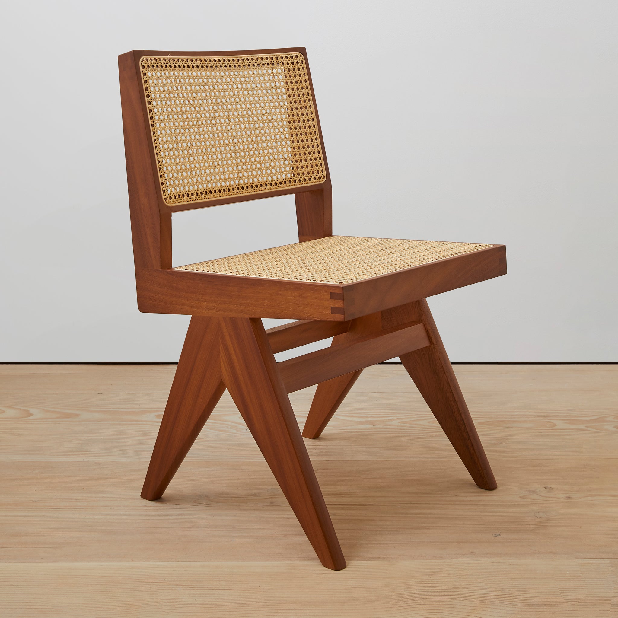 Main view of an authentic chandigarh side chair, pierre jeanneret era, teak frame, viennese cane, produced by Klarel. #K38-1