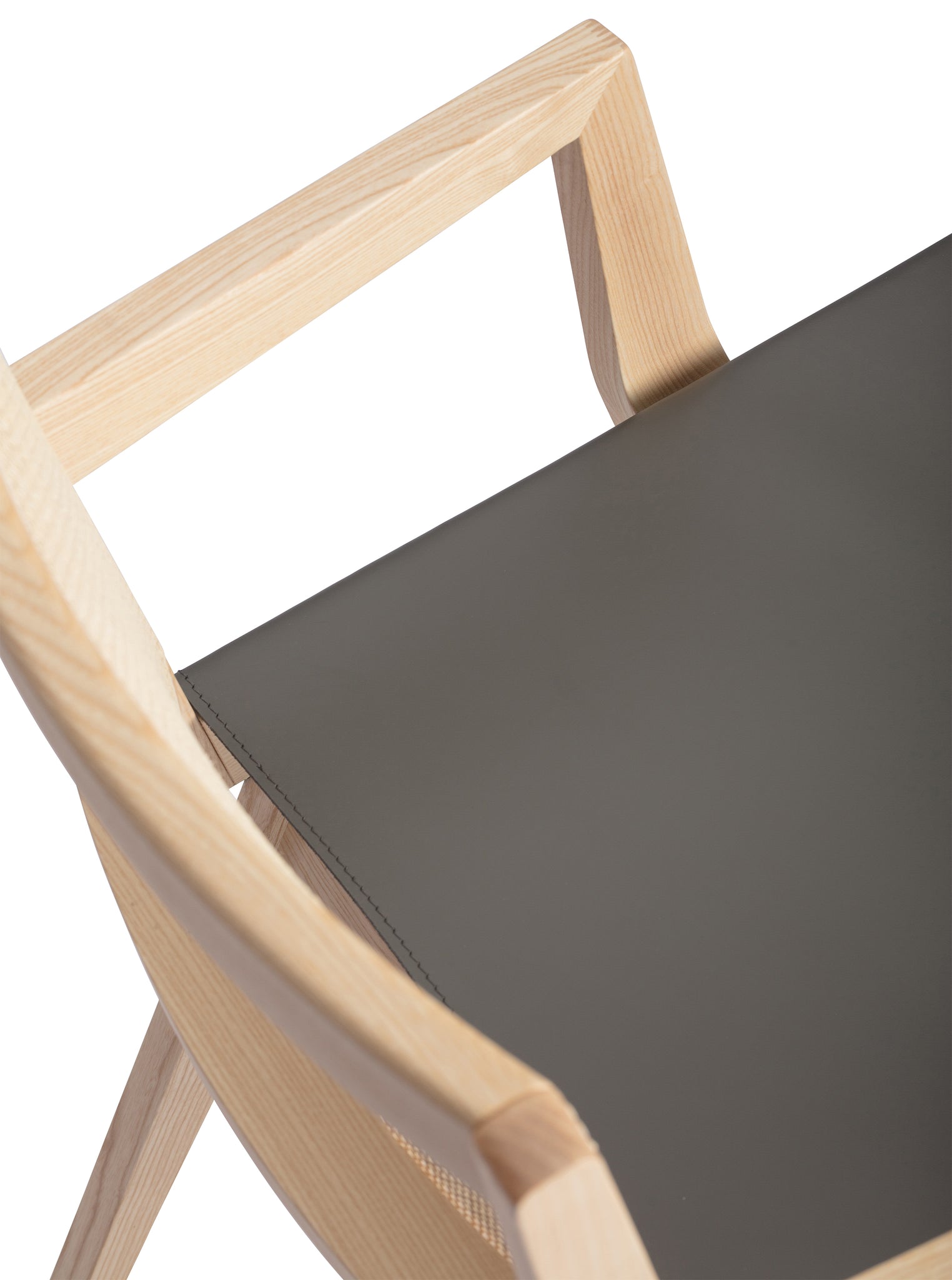 Close-up 2 of an "Elye" designer dining chair, walnut stained ash frame, square weave cane back, contract grade off white leather seat, produced by Klarel in Italy. #K40-3