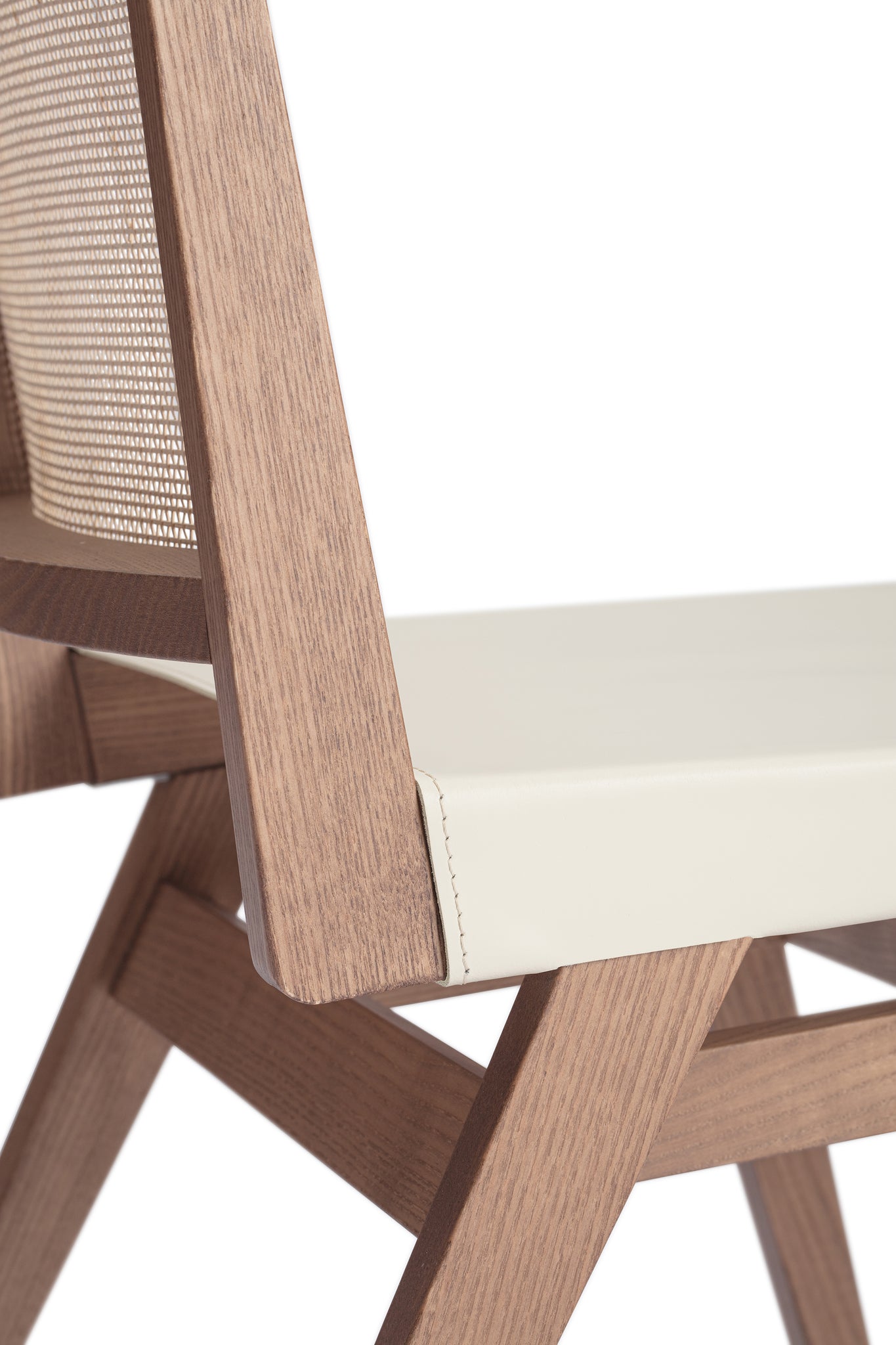 Close-up 1 of an "Elye" modern dining chair, walnut stained ash frame, square weave cane back, contract grade off white leather seat, produced by Klarel in Italy. #K41-1