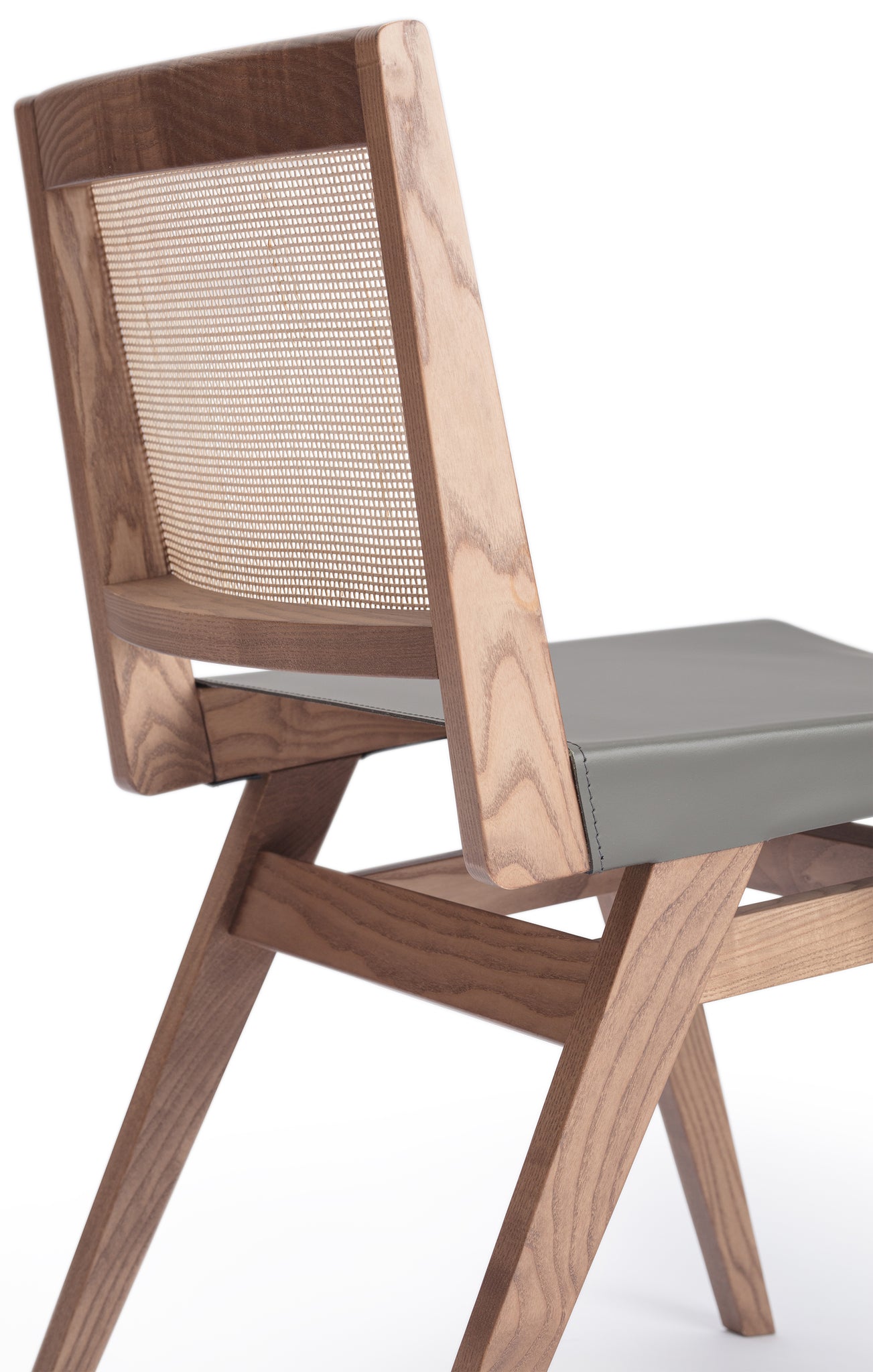 Close-up 2 of an Elye modern dining side chair, walnut stained ash frame, square weave cane back, contract grade gray leather seat, produced by Klarel in Italy. #K41-2