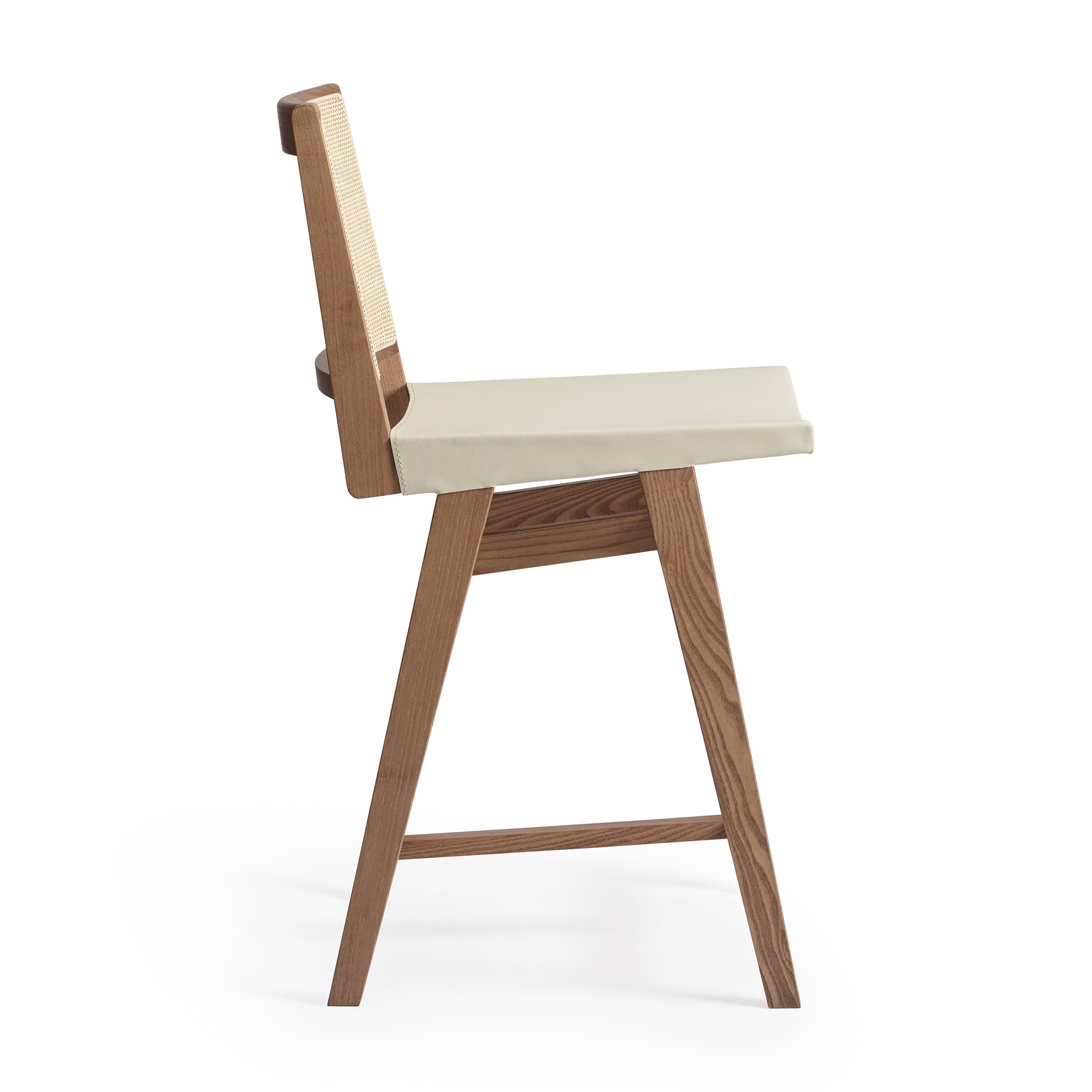 Side view of an Elye modern kitchen counter stool, walnut stained ash frame, square weave cane back, contract grade off white leather seat, produced by Klarel in Italy. #K43-1